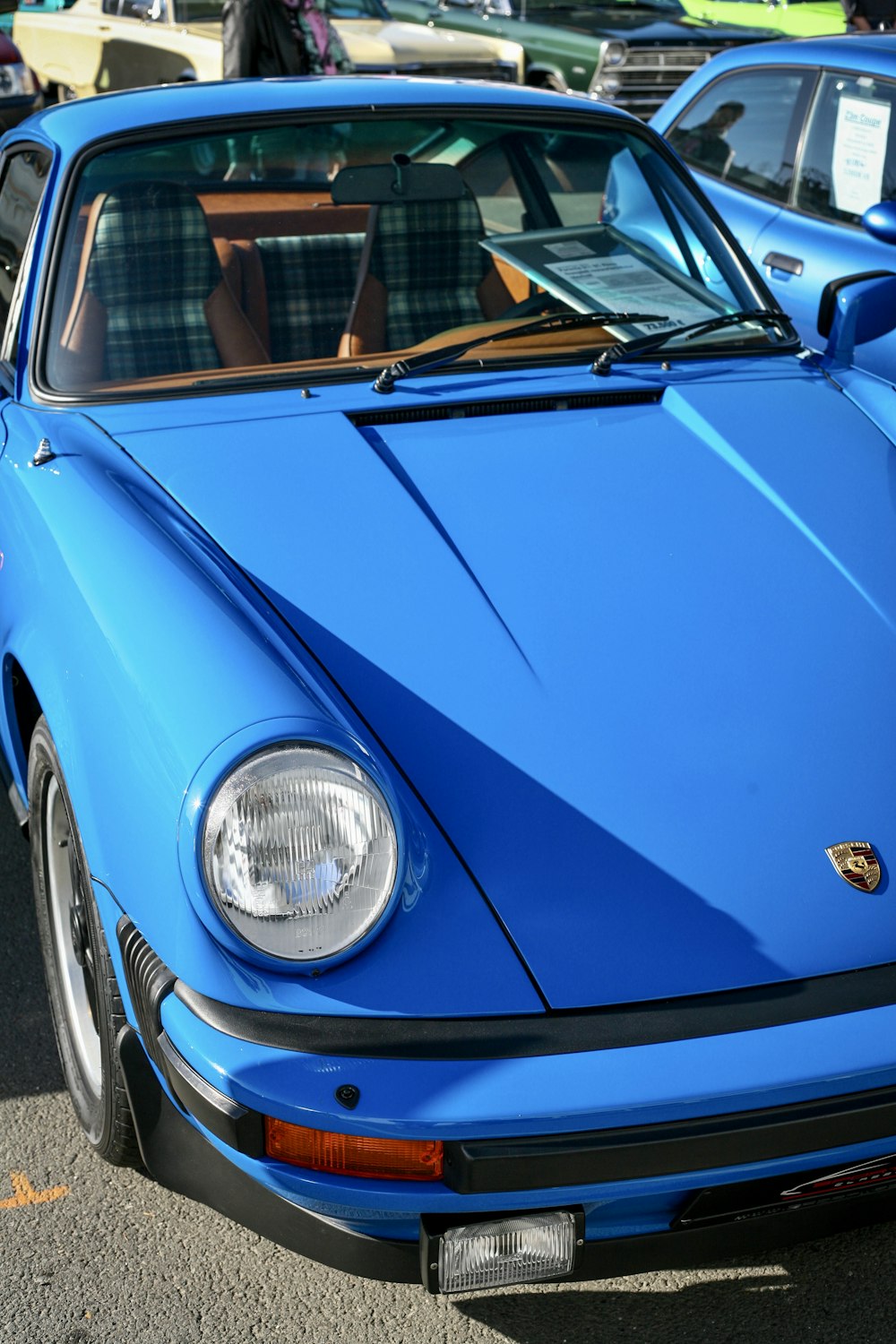 a blue sports car parked in a parking lot