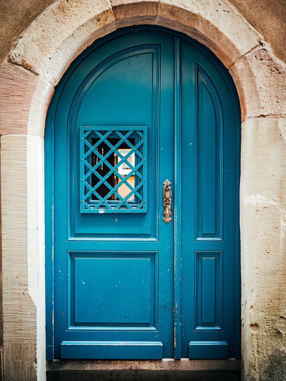 a blue door with a window on the side of it