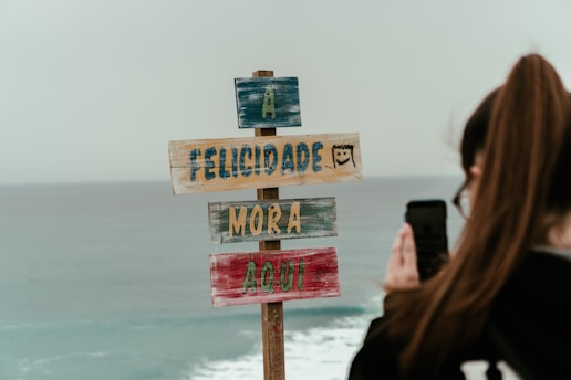 A vibrant photo of a traveler checking flight deals on a smartphone with Fortaleza's skyline in the background.