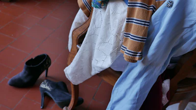 An inviting shot of trendy fashion items arranged on a rustic chair.