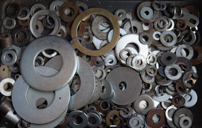 Stack of metal seals with different sizes displayed on a workshop bench