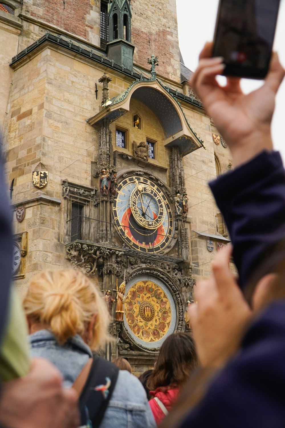 a person taking a picture of a clock tower