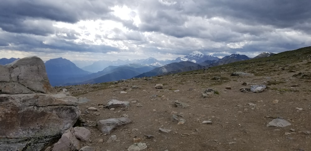 a view of a rocky mountain with a cloudy sky