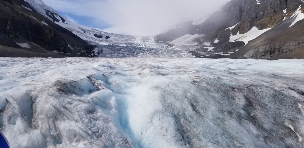 a view of a glacier with a mountain in the background