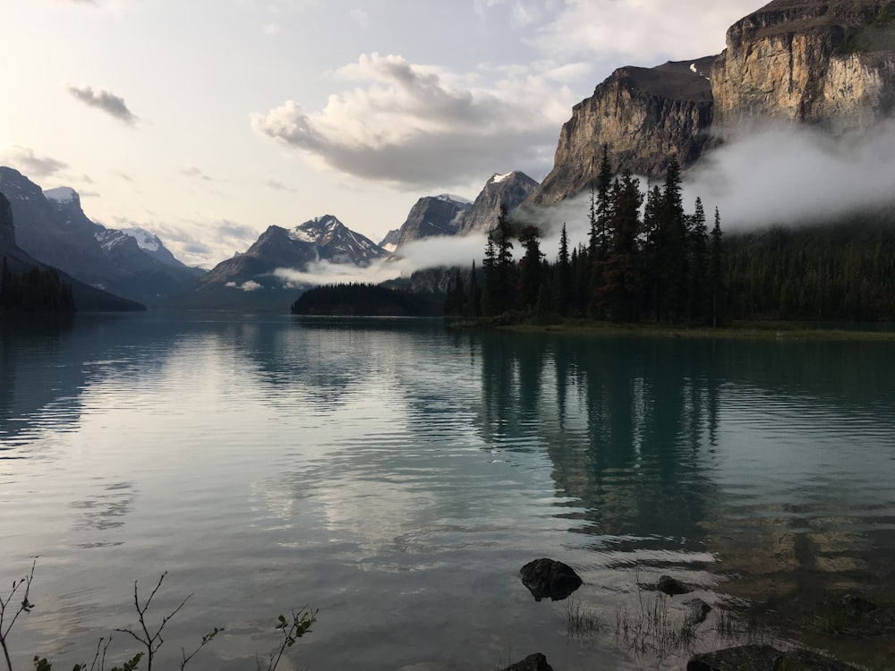 a body of water with mountains in the background