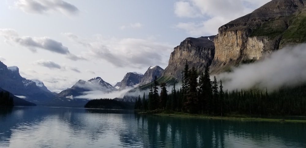 a body of water surrounded by mountains and trees