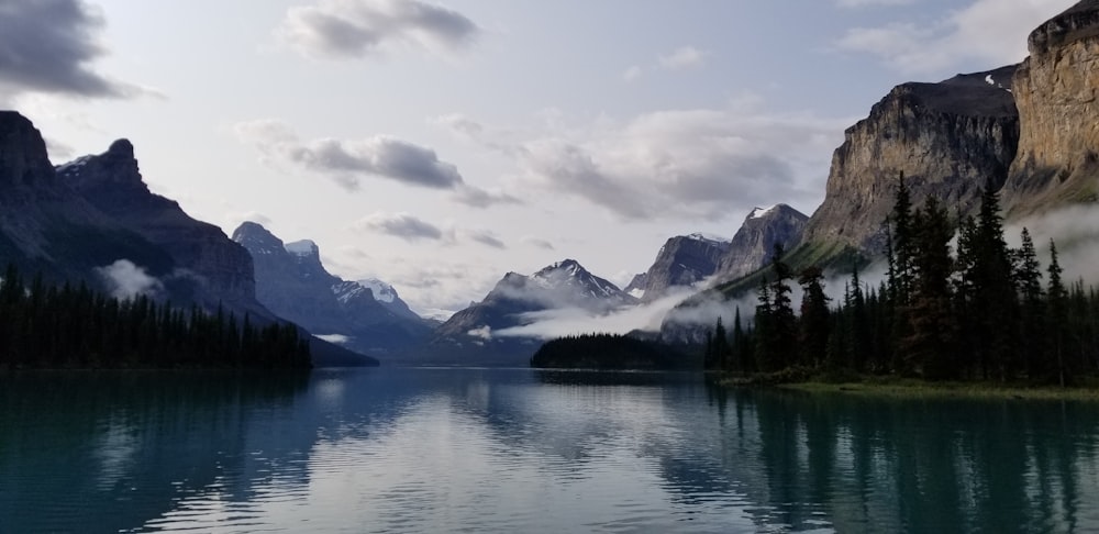 a body of water surrounded by mountains and trees