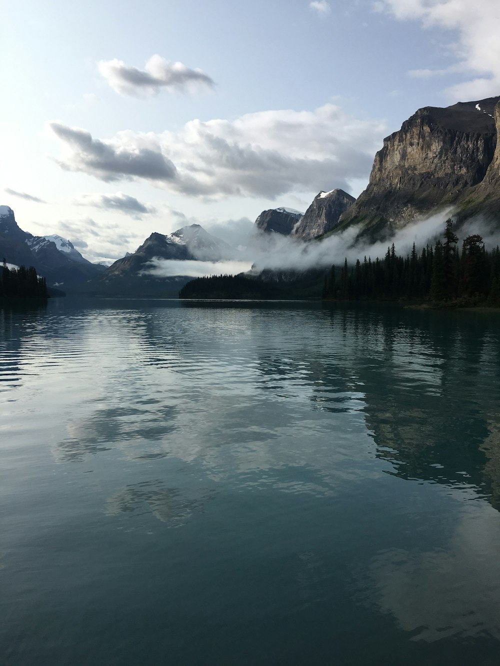 a body of water with mountains in the background