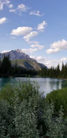 A serene mountain landscape with a winding river under a clear blue sky.