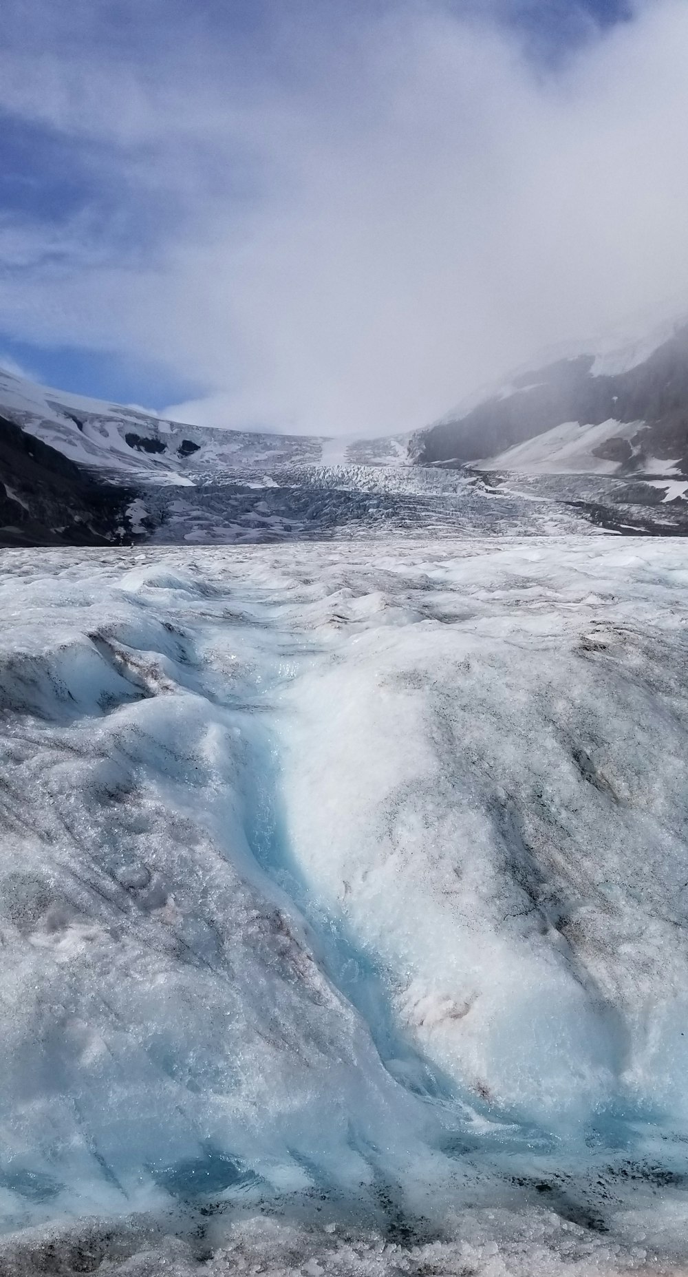 a large ice floet with a mountain in the background