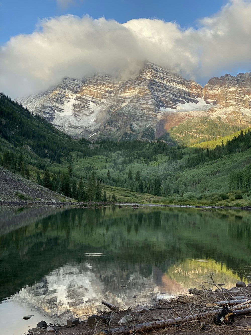 a mountain range with a lake in the foreground