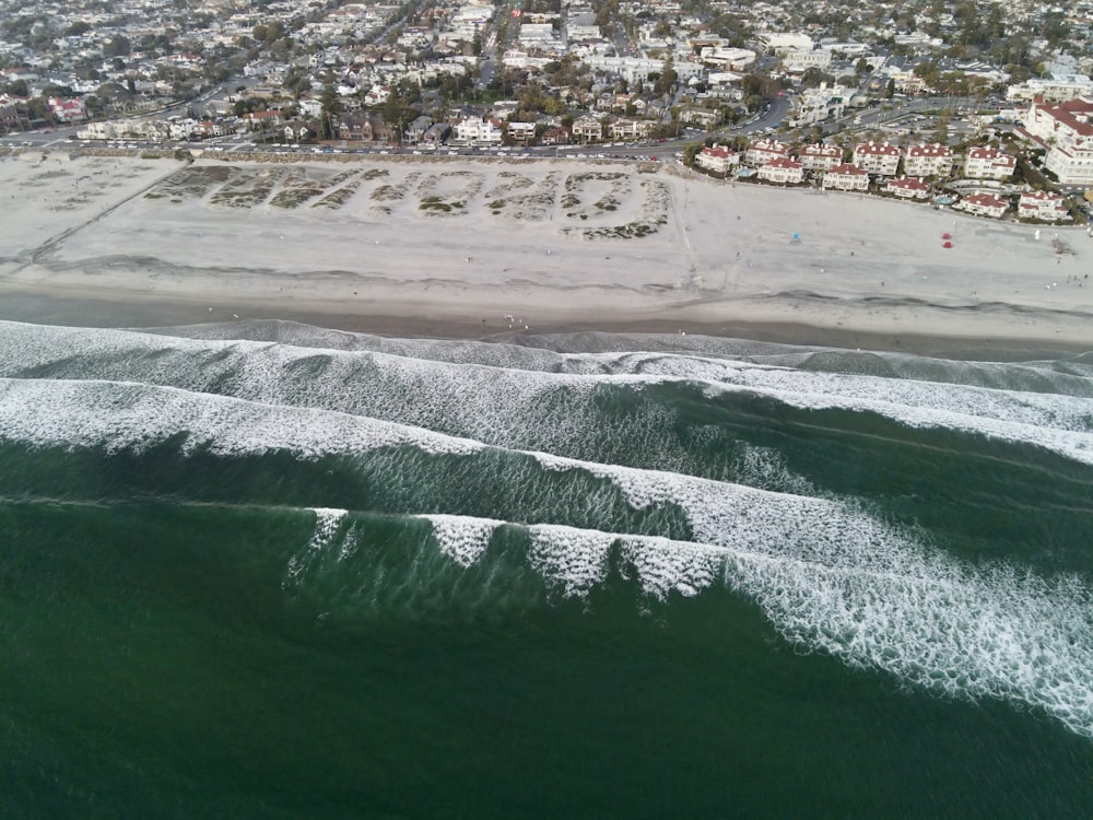 an aerial view of the ocean and a city