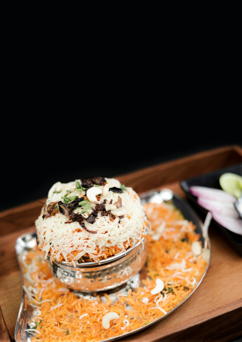 a wooden tray topped with a bowl of food