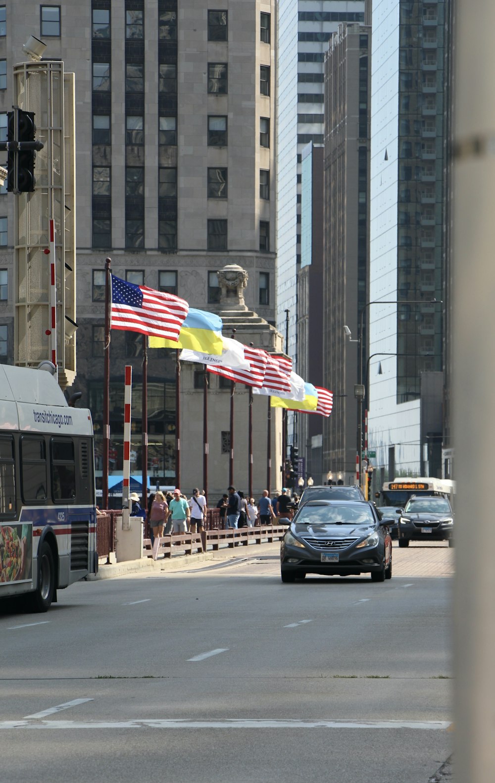 a bus driving down a street next to tall buildings