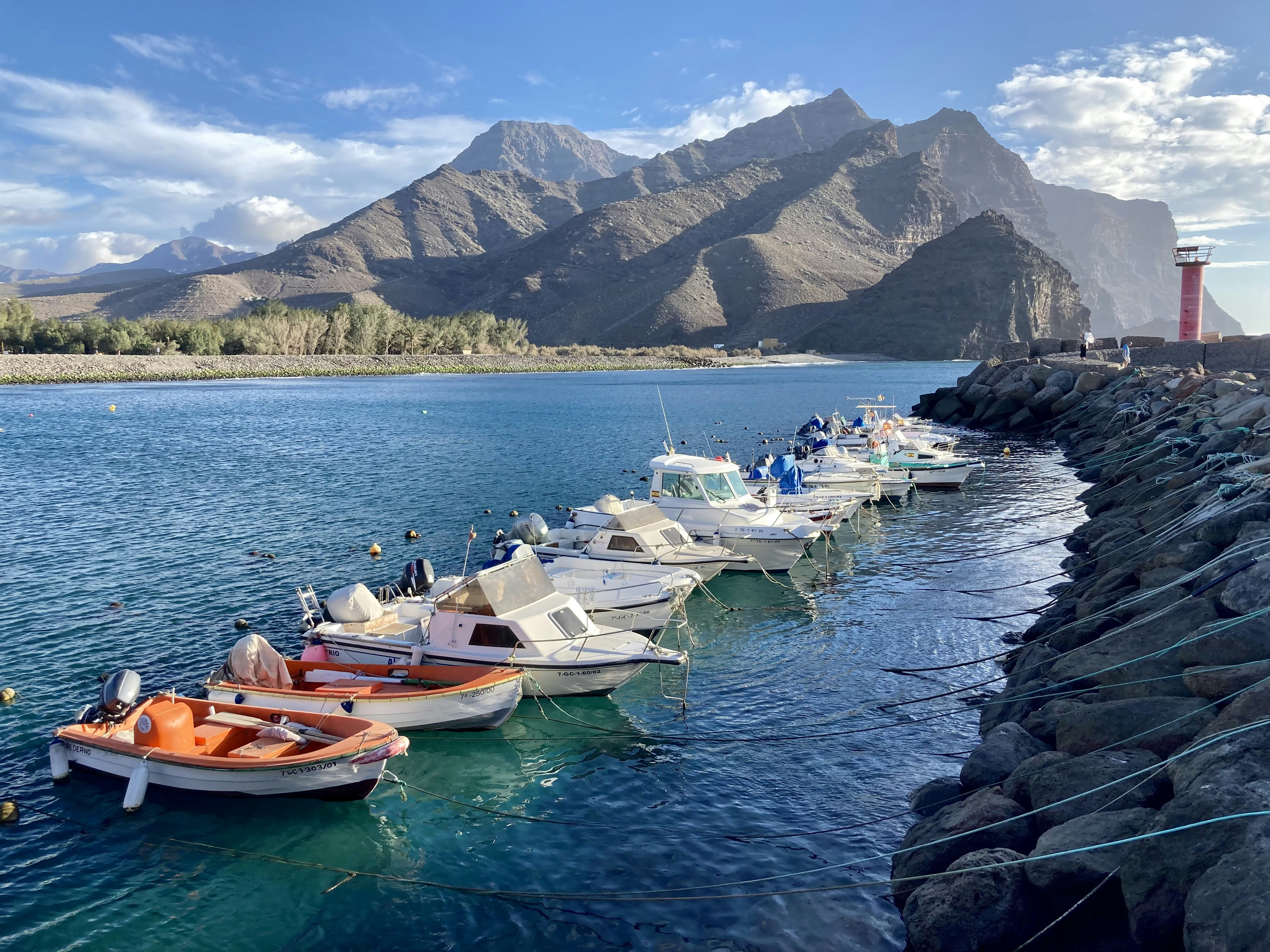 a row of boats sitting on top of a body of water