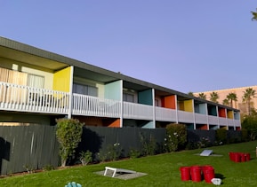 a row of multi - colored apartment buildings on a sunny day