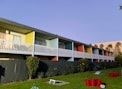 a row of multi - colored apartment buildings on a sunny day