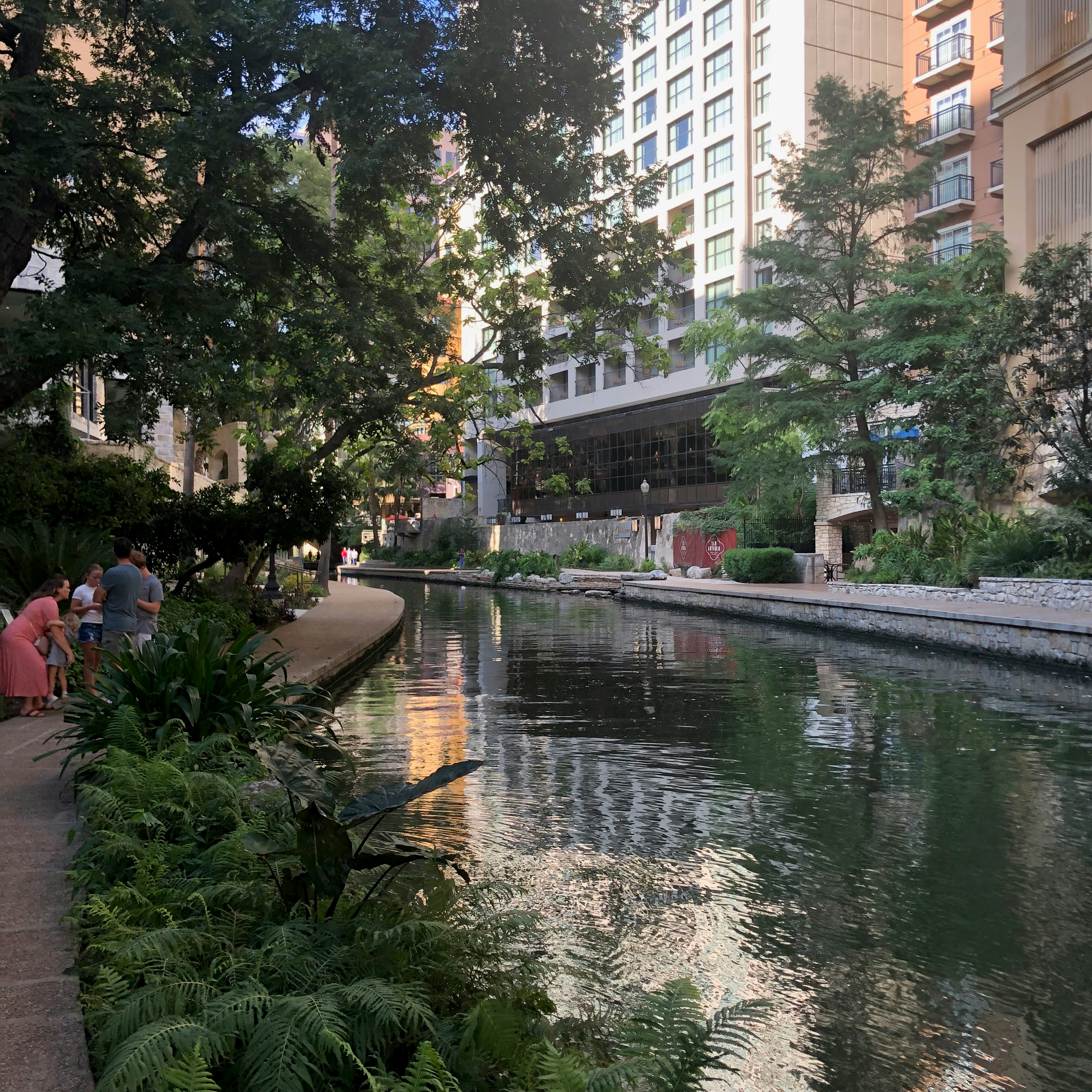 a river running through a city next to tall buildings