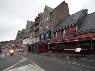 Historic stone houses lining a quiet street in La Roche-Guyon, showcasing Norman architecture