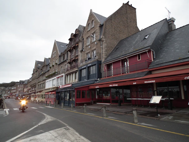 Historic stone houses lining a quiet street in La Roche-Guyon, showcasing Norman architecture