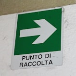 Yellow-highlighted eco-friendly signage at the entrance of Comercializadora JJVC's collection center in Medellín