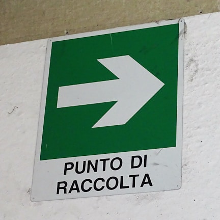 Yellow-highlighted eco-friendly signage at the entrance of Comercializadora JJVC's collection center in Medellín