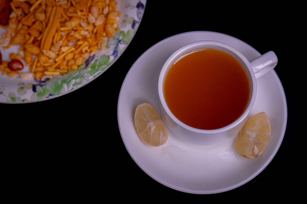 a cup of tea next to a plate of food