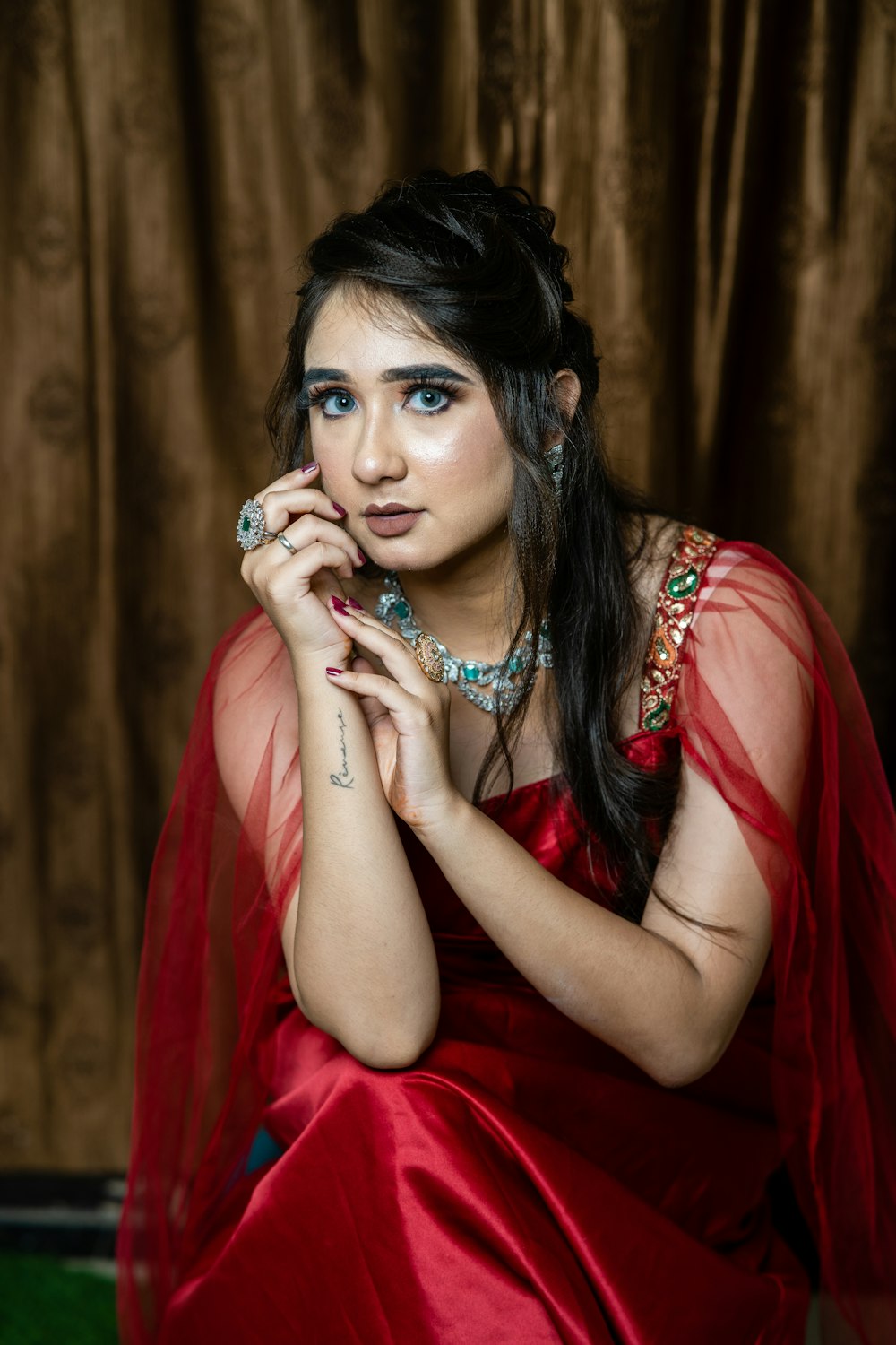 a woman in a red dress posing for a picture