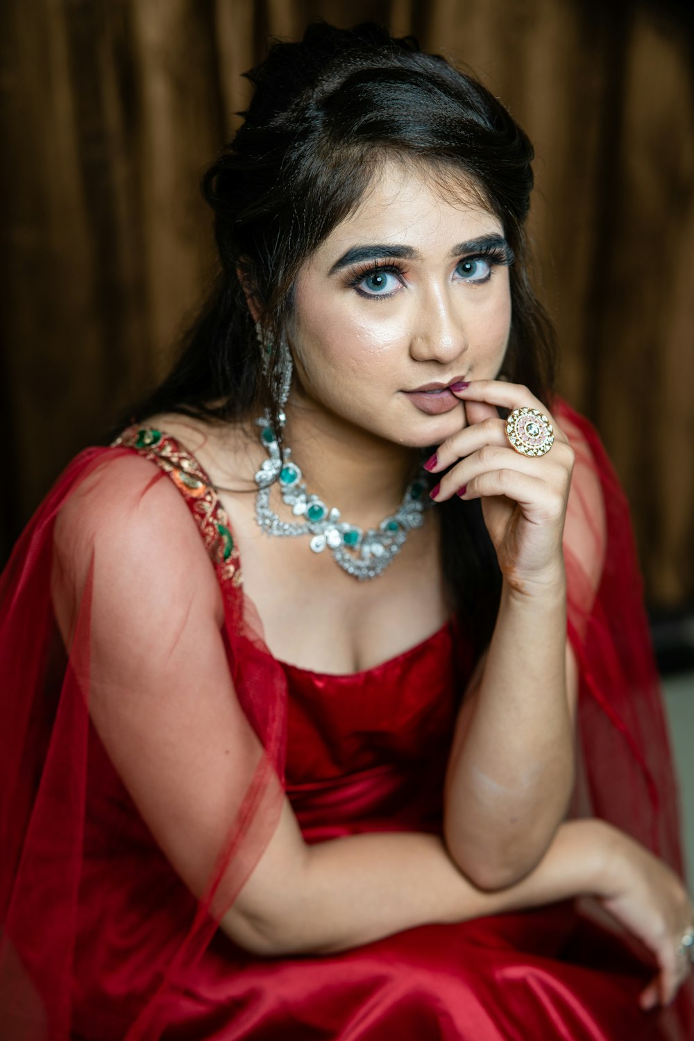 a woman in a red dress posing for a picture