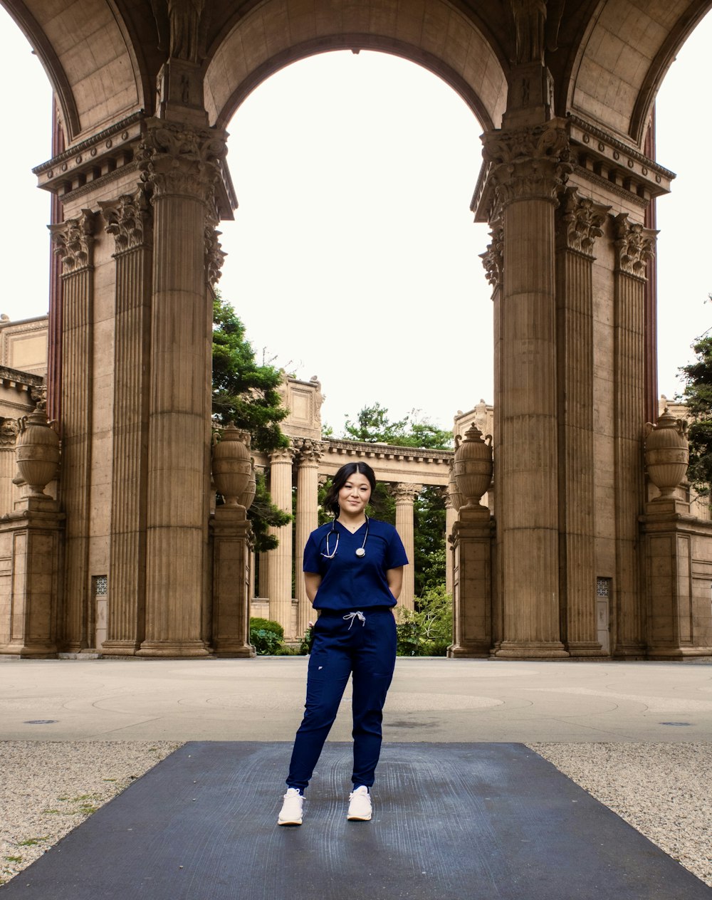 a woman standing in front of an archway
