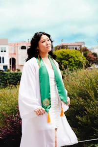 Smiling healthcare graduate in a white coat