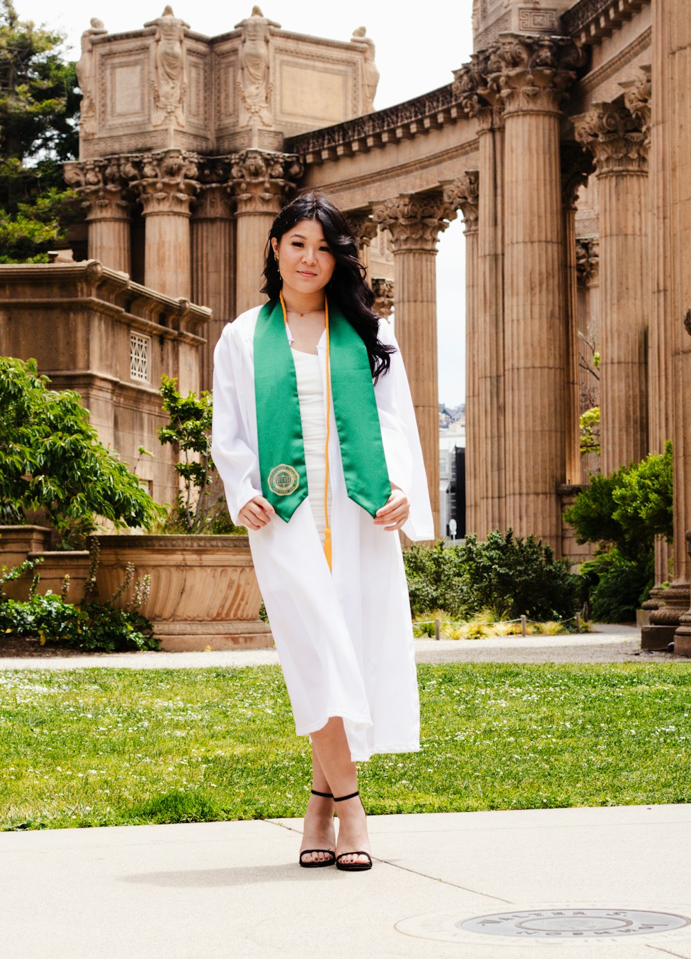 a woman in a white dress and green scarf