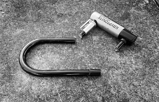 a black and white photo of a hair dryer laying on the ground