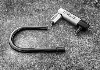 a black and white photo of a hair dryer laying on the ground