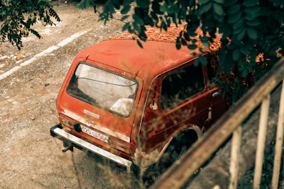 A broken-down SUV parked on a suburban street ready for pickup.