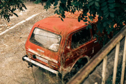 A non-running SUV with a flat tire, waiting to be picked up for donation.