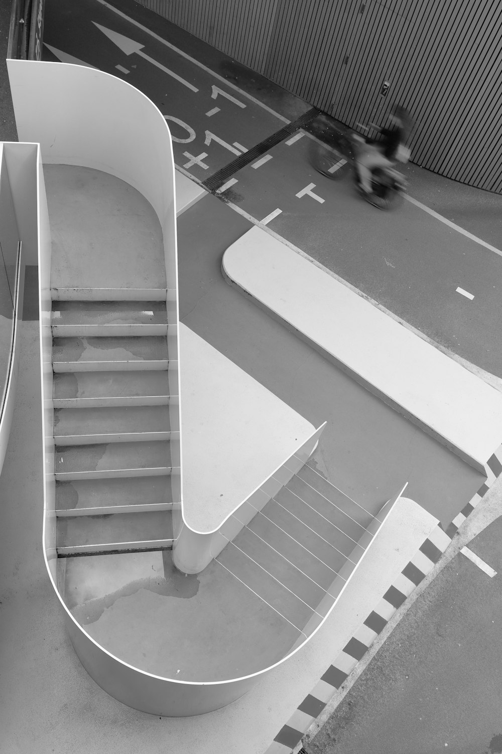 a black and white photo of a spiral staircase