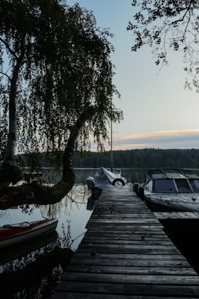 Private dock extending into the lake with a kayak tied up, ready for a peaceful paddle.