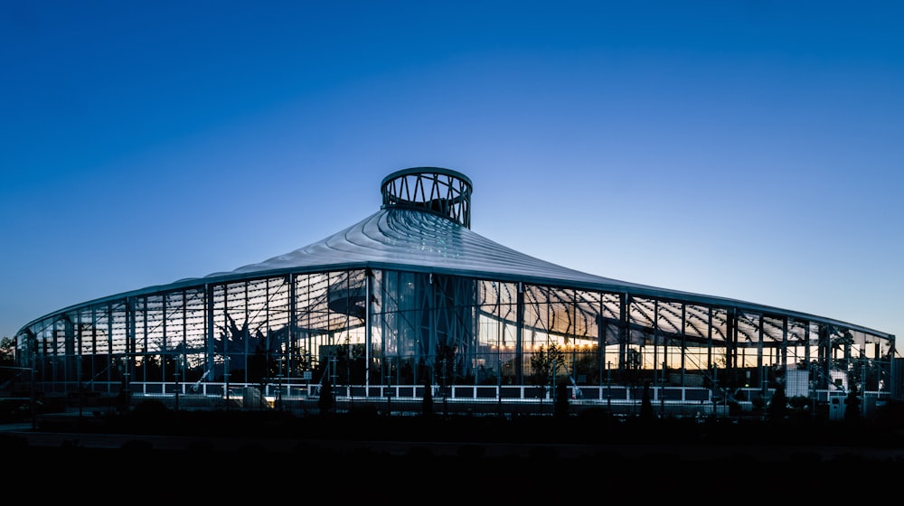 a large glass building sitting under a blue sky