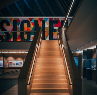 a staircase leading up to a sign in a building