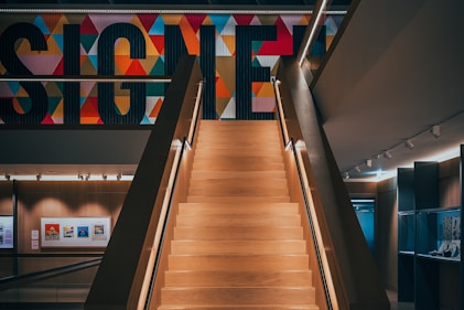 a staircase leading up to a sign in a building