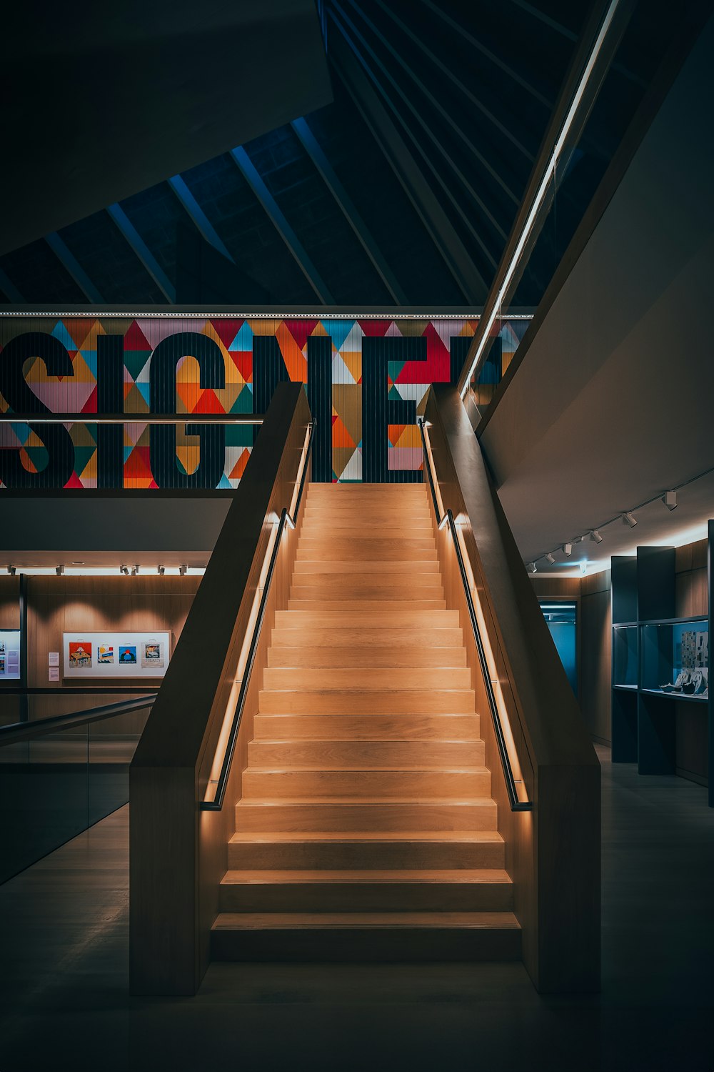 a staircase leading up to a sign in a building