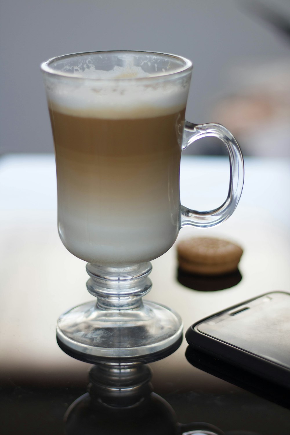 a cup of coffee sitting on top of a table