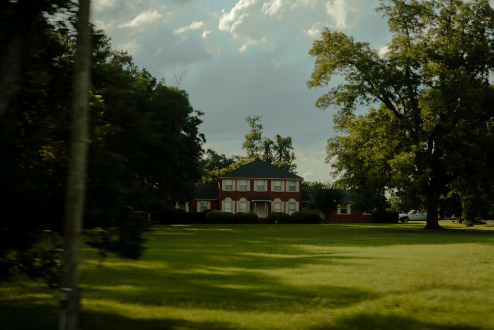 a house in the middle of a grassy field