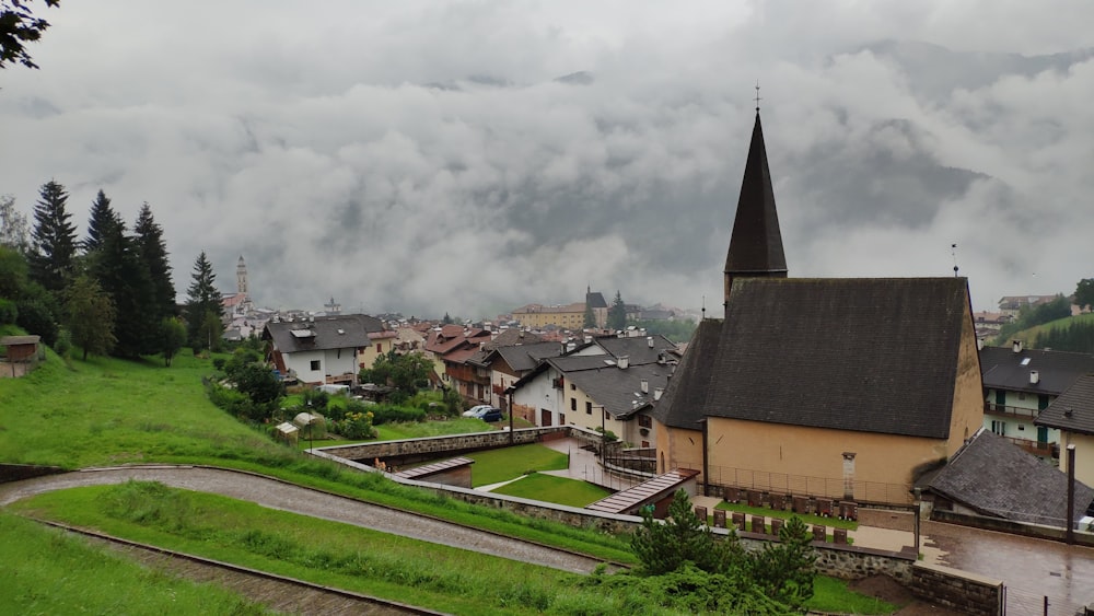 a small village with a steeple on a cloudy day