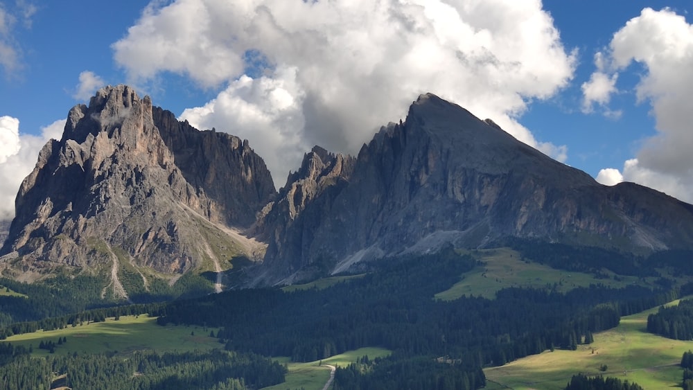 a view of a mountain range with clouds in the sky