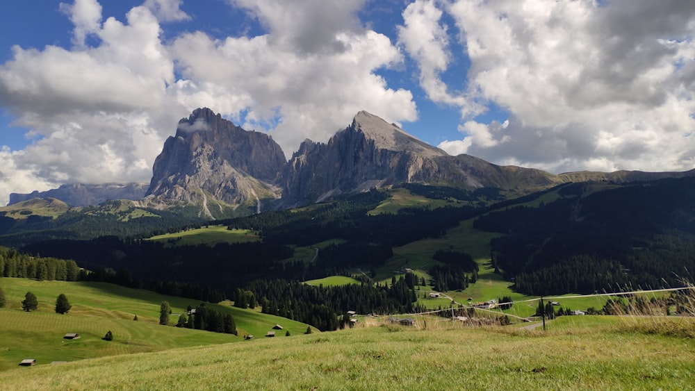 a scenic view of a mountain range with clouds in the sky