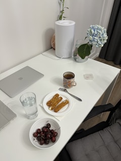A clean, organized desk with a small potted plant and a cup of herbal tea.
