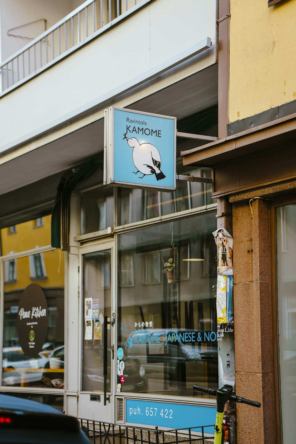 a store front with a blue sign hanging from the side of it