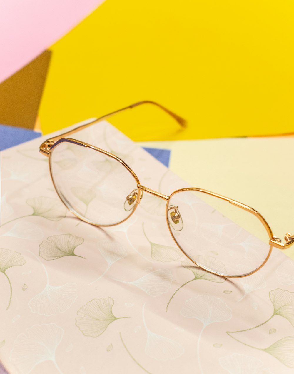 a pair of glasses sitting on top of a piece of paper